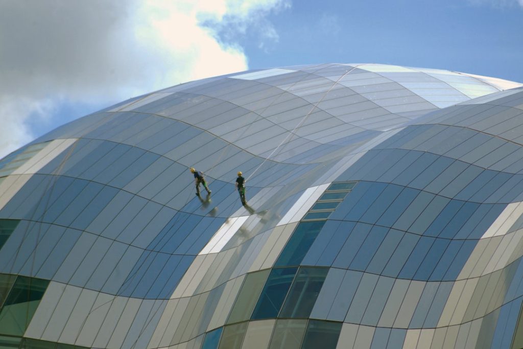 Walking along the Quayside, Newcastle upon Tyne, England and captured two workman on the glass roof of the Sage Theatre, Gateshead on the opposite side of the River Tyne.